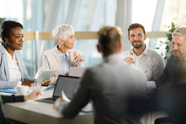 istock Happy entrepreneurs talking during a constructive meeting in the office. 1420927642