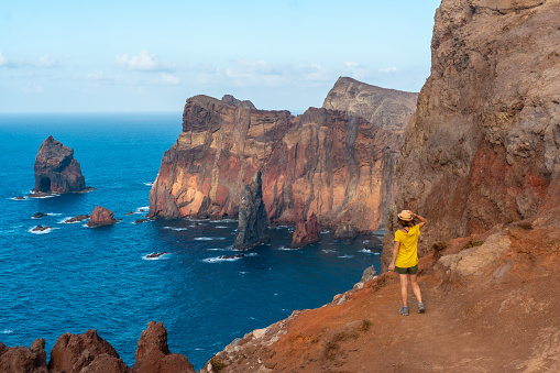 A young woman in Ponta de Sao Lourenco in summer looking at the landscape, Madeira