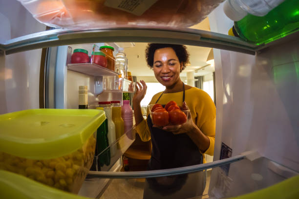 istock Woman looking at food in refrigerator 1420929692