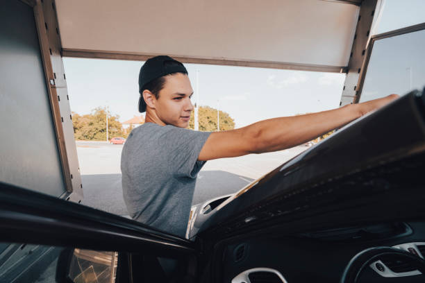 istock Young man washing car 1420931937