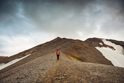 Group of expedition hiker hiking on top of the mountain in Icelandic highlands on Blahnjukur trail at Landmannalaugar, Iceland