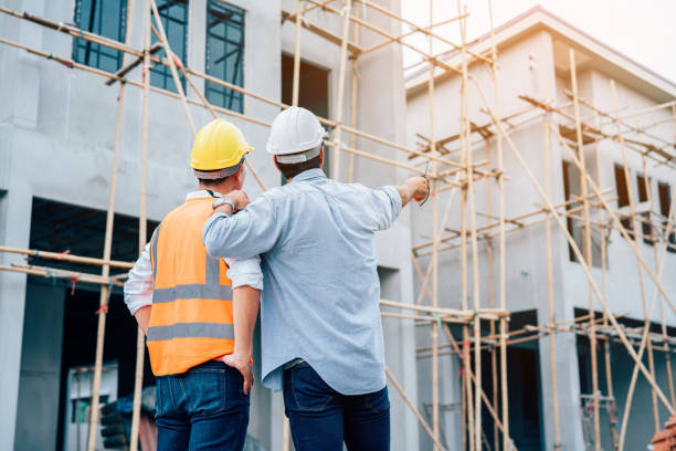 istock Engineers or leader discussion and pointing to construction site. 1420932222