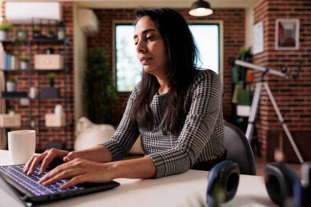 istock Indian woman working on laptop website 1420933312