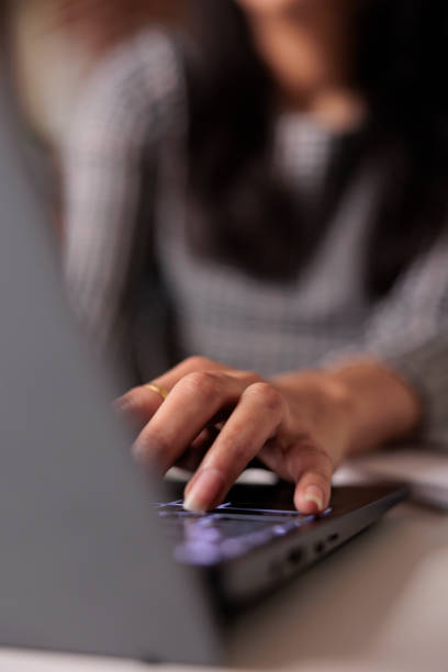 istock Young adult typing information on laptop 1420933501
