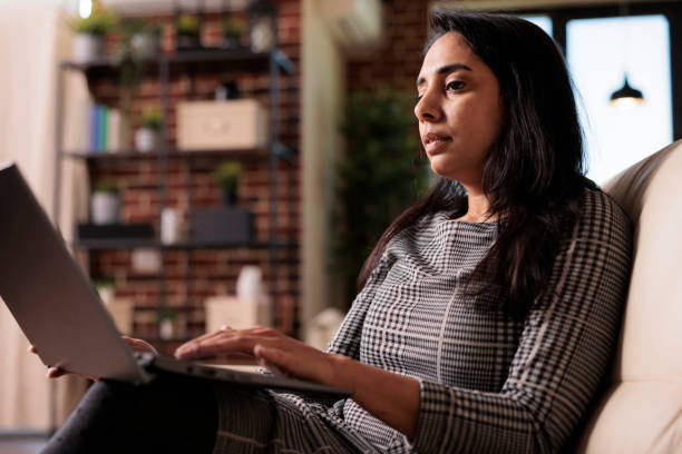 istock Business woman sitting on couch and working 1420934777
