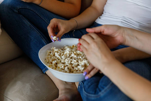 istock Snacking on a bowl of popcorn while relaxing and watching a movie 1420937238