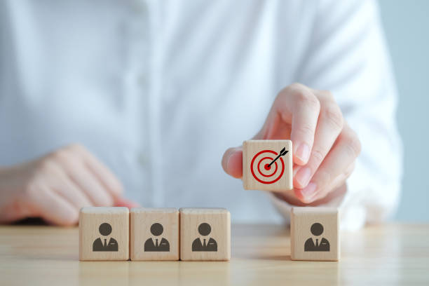 istock Teamwork.  Successful team. Business achievement goal and objective target. Team growing business success concept. Teamwork with team businessman on wooden circle and hand holding dartboards target. 1420940449