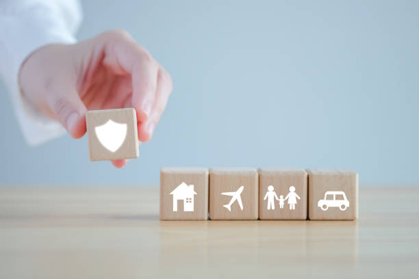 istock Insurance concept. Protection against a possible eventuality. Hand holding security icon and House, Car, Family and travel icon on wooden block for assurance life concept. 1420940575