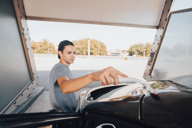 istock Young man washing car 1420942303