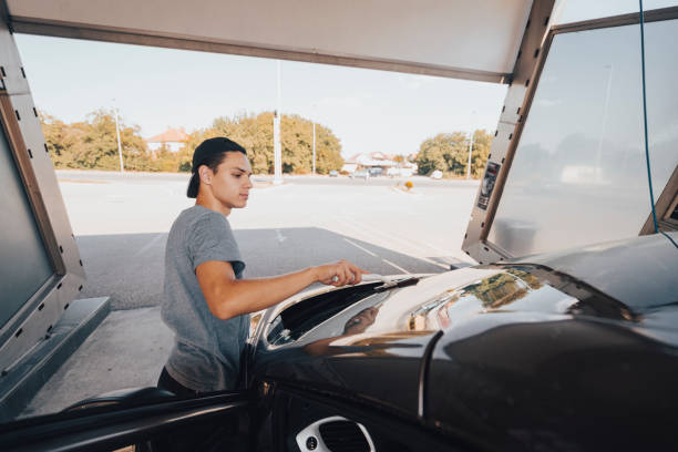 istock Young man washing car 1420942305