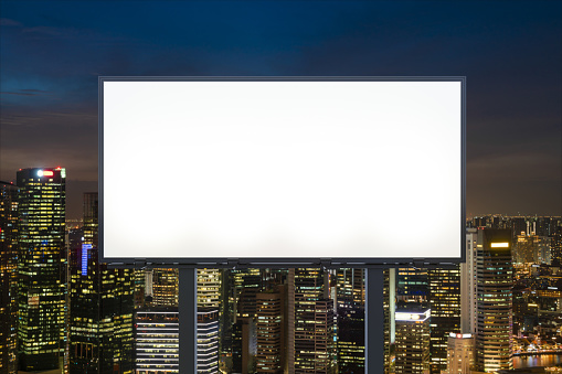Blank white road billboard with Singapore cityscape background at night time. Street advertising poster, mock up, 3D rendering. Front view. The concept of marketing communication to sell idea.