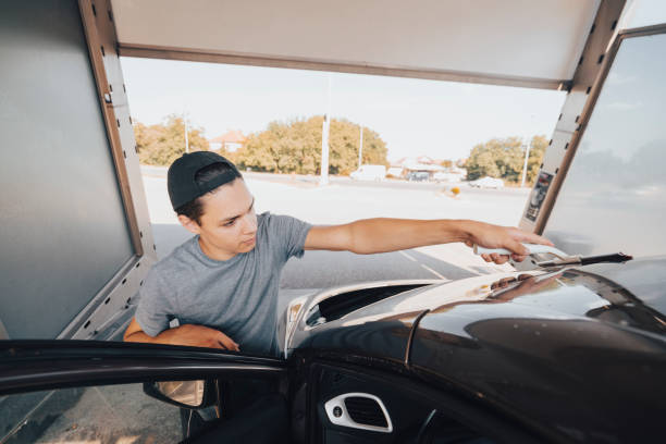 istock Young man washing car 1420942640