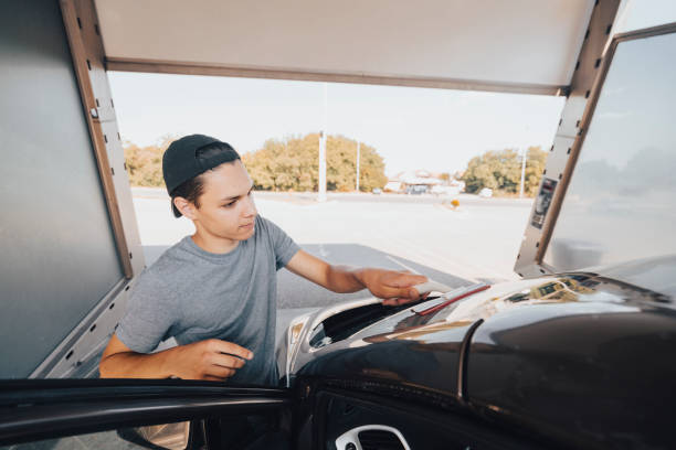 istock Young man washing car 1420942661