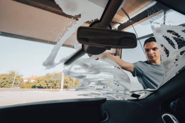 istock Young man washing car 1420942887
