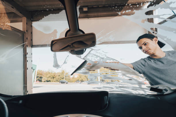 istock Young man washing car 1420942894