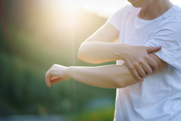 istock Close up woman's hand holding her elbow . 1420944525