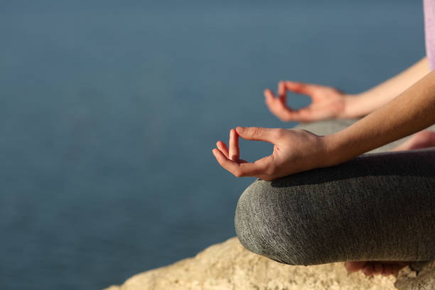 istock Yogi hands doing yoga exercise in a lake 1420945209