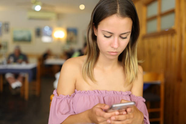 istock Woman in a restaurant using smart phone 1420945325