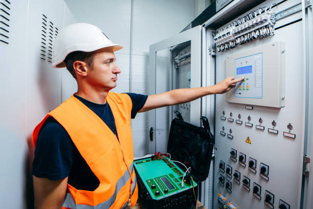 istock Adult electrician builder engineer testing and screwing equipment of device for secondary current and voltage testing of relay protection and automation devices of modern electricity power station. 1420952401