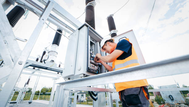 istock Adult electrical engineer inspect the electrical systems at the equipment control cabinet. Installation of modern electrical station 1420952444