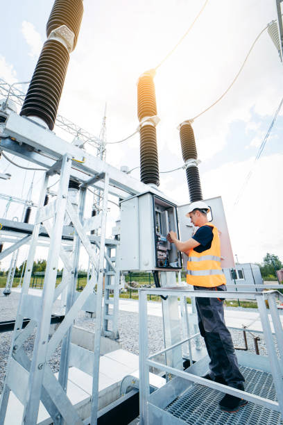 istock Adult electrical engineer inspect the electrical systems at the equipment control cabinet. Installation of modern electrical station 1420952505