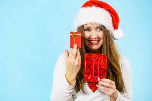 istock Happy Christmas woman holds red gift box 1420955450