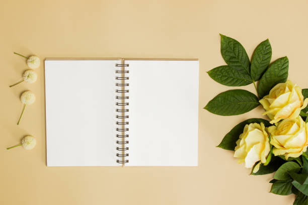 istock Notebook with roses and leaves over the brown background. 1420957834