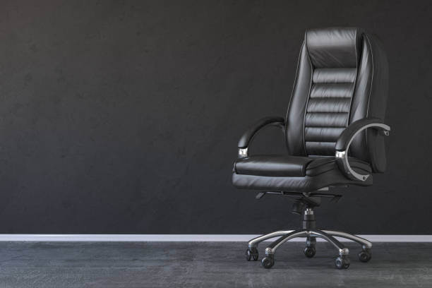 Black office chair in black interior with space for text. stock photo
