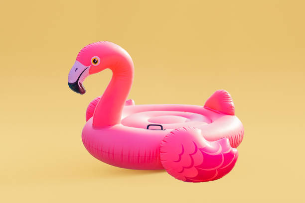 istock Pink inflatable flamingo on yellow background 1420972370