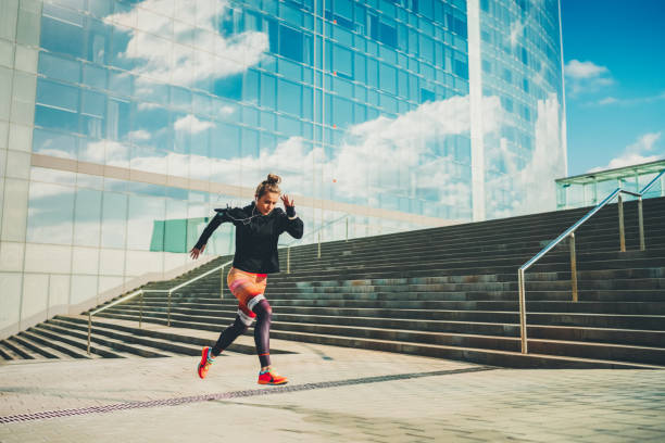 sportlerin sprintet in der stadt - warming up fotos stock-fotos und bilder