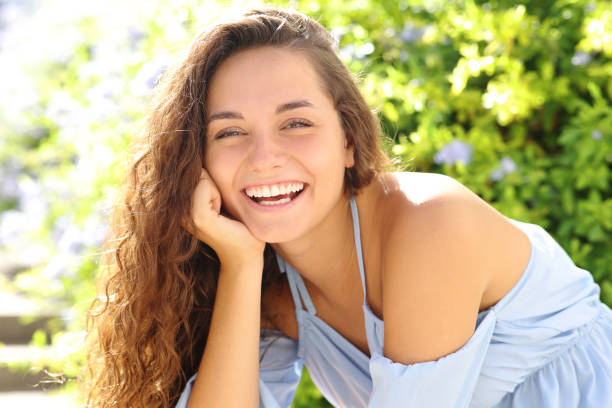 istock Happy woman smiling at camera in a garden 1420973214