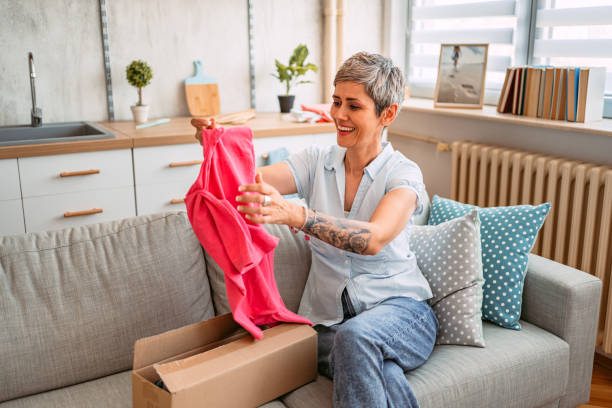 istock Senior Woman Opening A Package She Ordered Online 1420973426
