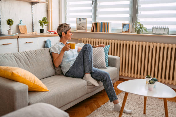 istock Senior Woman Sitting On The Sofa And Drinking Coffee 1420974942