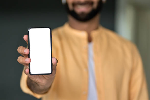 istock Man holding in hand showing white mock up phone screen cellphone ads template. 1420975135