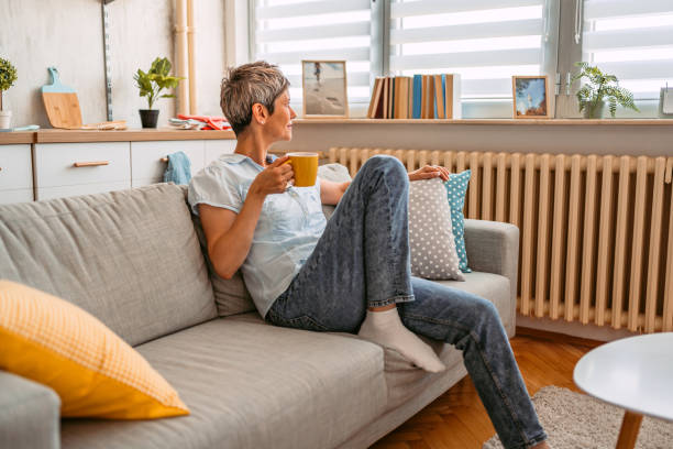 istock Senior Woman Sitting On The Sofa And Drinking Coffee 1420975920