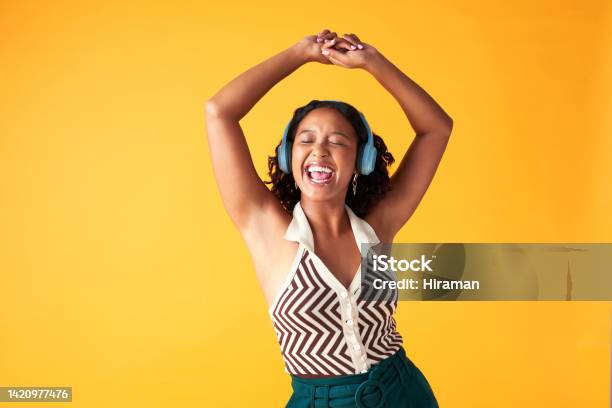 Dance Music And Creative Woman Listening With Wireless Headphones In Photographer Studio Background Happiness Freedom And Relax Female Singing While Streaming Radio Or Spotify In Yellow Backdrop Stock Photo - Download Image Now