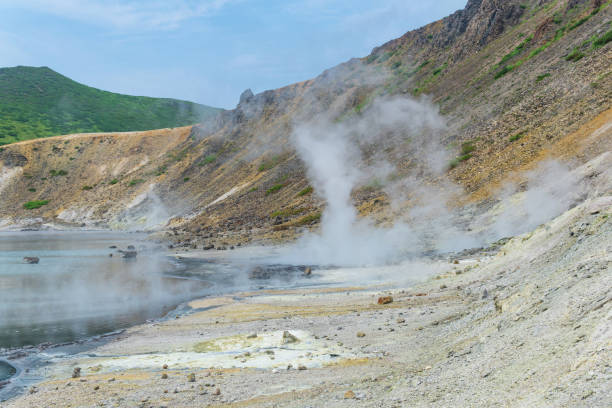 hot mineralized lake with thermal spring and smoking fumaroles in the caldera of the Golovnin volcano on the island of Kunashir hot mineralized lake with thermal spring and smoking fumaroles in the caldera of the Golovnin volcano on the island of Kunashir kunashir island stock pictures, royalty-free photos & images