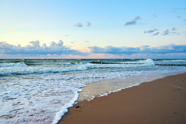 Sea sand beach landscape. Seascape background. Sunset sky over ocean water surface with calm waves, Summer mood and vacation travel holiday