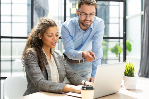 istock Two collegues discussing documents and other working moments in office. 1420982341