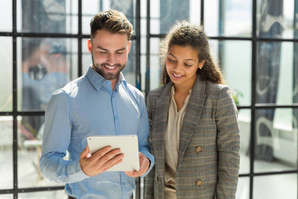 istock Modern business people are working using digital tablet and smiling while standing in the office. 1420982466
