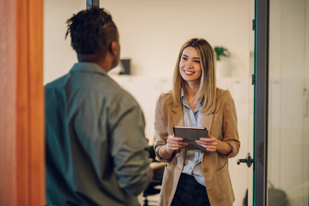 istock Two multiracial business colleagues working together on a digital tablet 1420982555