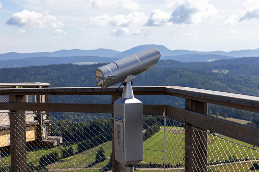 Telescope on the observation tower located at the top of the Sotwiny Arena ski station, leading in the treetops, beautiful panorama of the mountain peaks, Krynica Zdroj, Beskid Mountains, Slotwiny, Poland