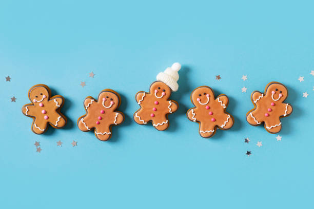 istock Row gingerbrads men on stick on blue background 1420983146