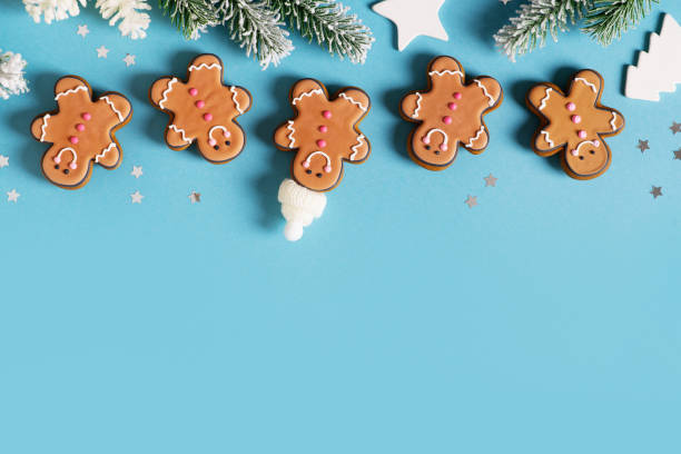 istock Row gingerbrads men on stick on blue background 1420983149