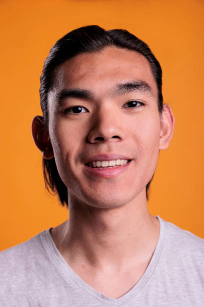 istock Young cheerful smiling asian man portrait close up 1420983607