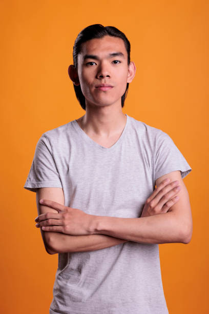 istock Serious young asian man standing in confident pose 1420983618