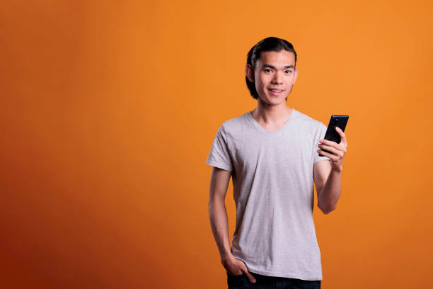 istock Young asian man messaging on smartphone 1420984201