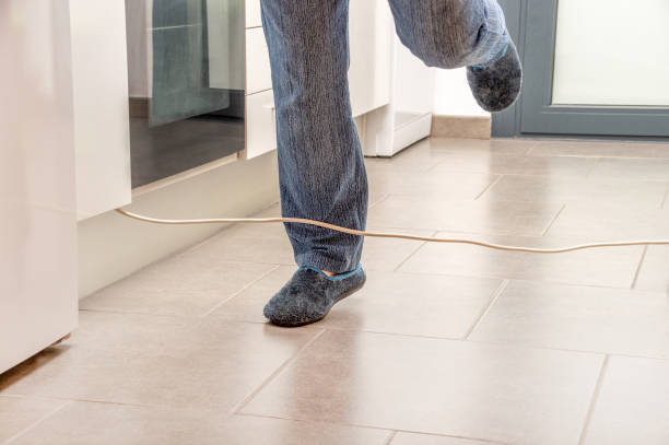 istock woman stumbling with an electrical cord 1420989587