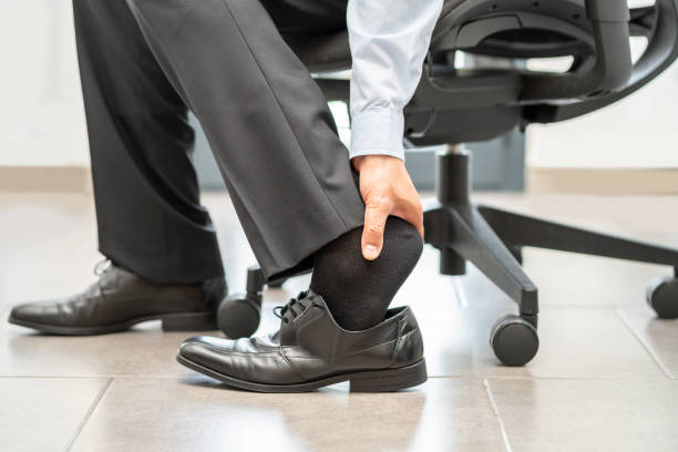 istock business man touching feet 1420989627