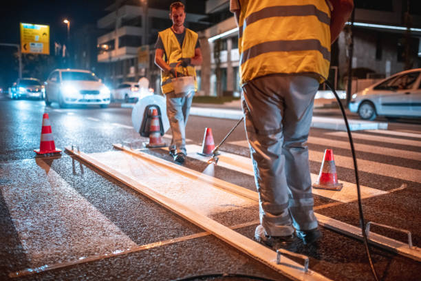 istock Spray Painting A Crosswalk With A Spray Gun 1420989729